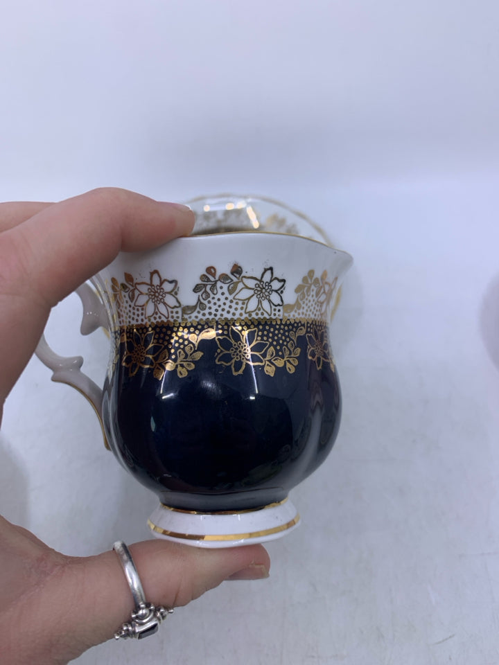 BLACK/WHITE W/ GOLD LACE DETAIL TEACUP/SAUCER.