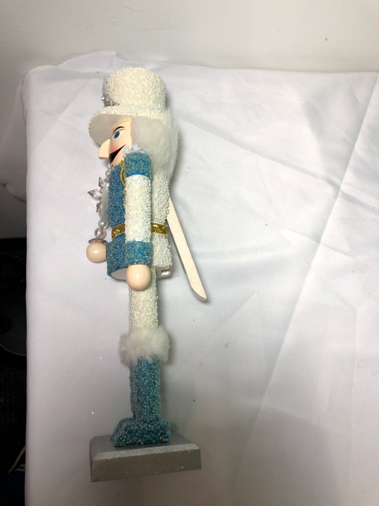 LIGHT BLUE AND WHITE SNOWFLAKE NUT CRACKER.