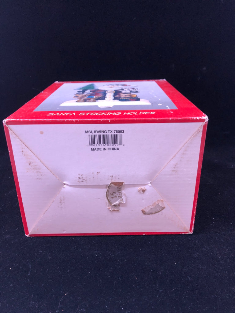 NIB WOOD CARVED SANTA W/PUPPIES STOCKING HOLDER.