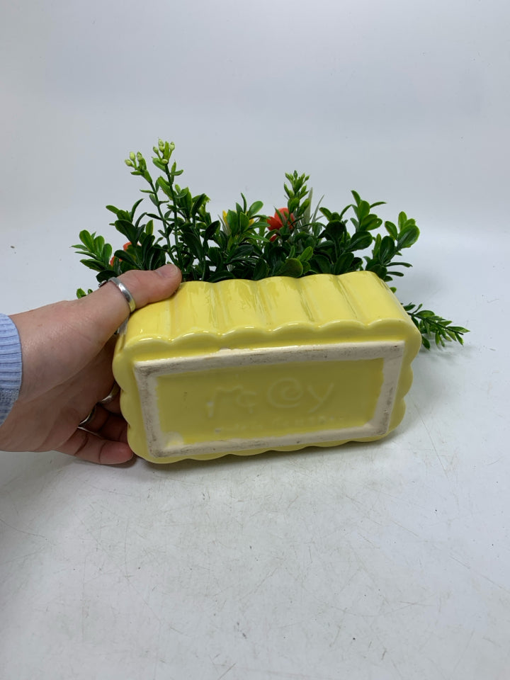 YELLOW PLANTER W/ FAUX FLOWERS.