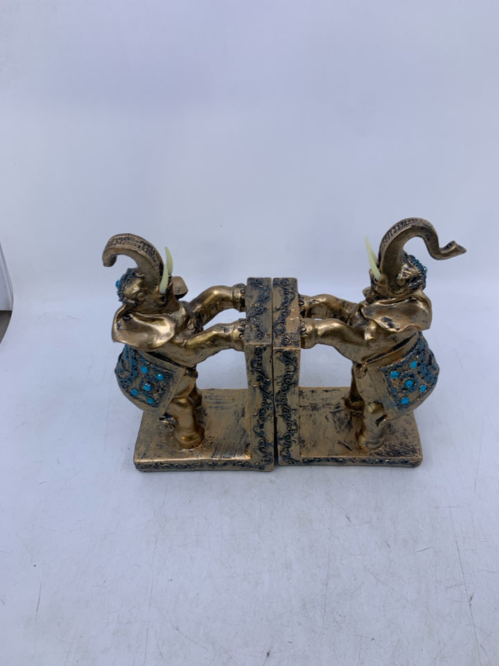 RESIN ELEPHANTS PAINTED GOLD W/ BLUE DETAILS.