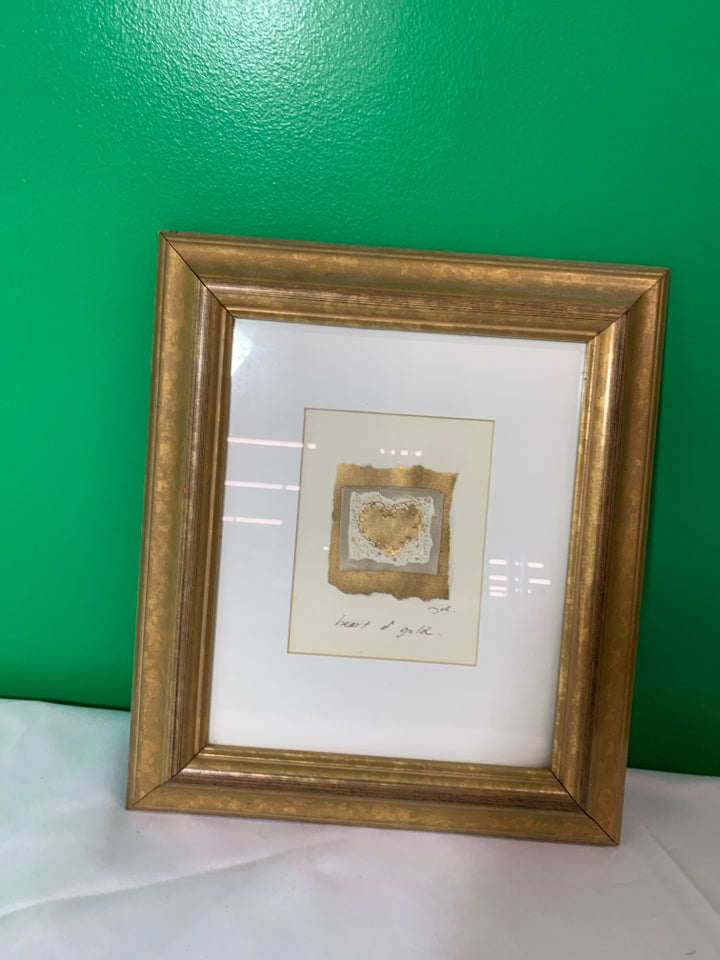 SMALL HEART OF GOLD WALL HANGING IN GOLD FRAME.