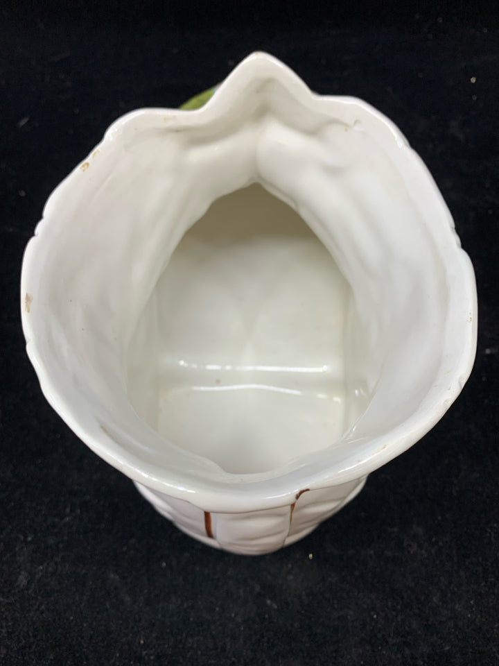 WHITE CERAMIC BOOT PLANTER W/PINK FLOWERS.