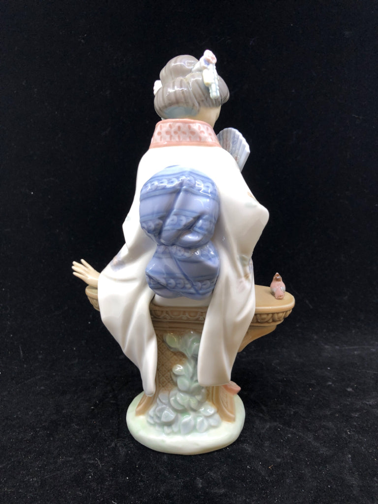 LLADRO WOMAN SITTING ON BENCH.