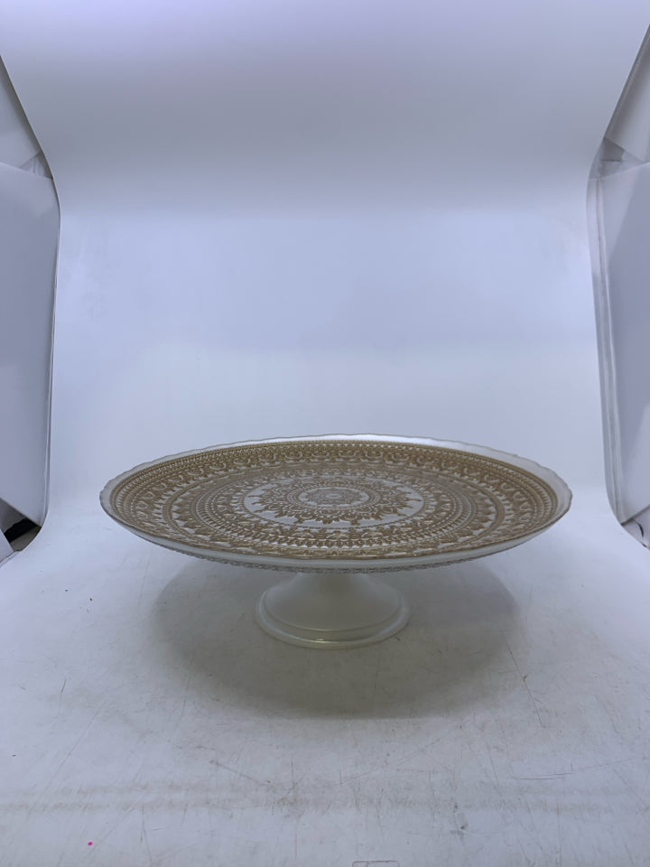 WHITE GLASS FOOTED CAKE STAND W/ GOLD EMBOSSED DESIGN.