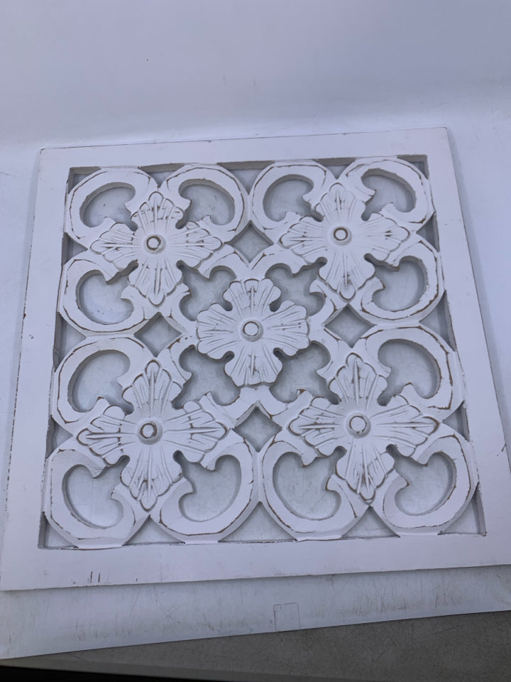 SQUARE WHITE WOOD CUTOUT WALL HANGING.
