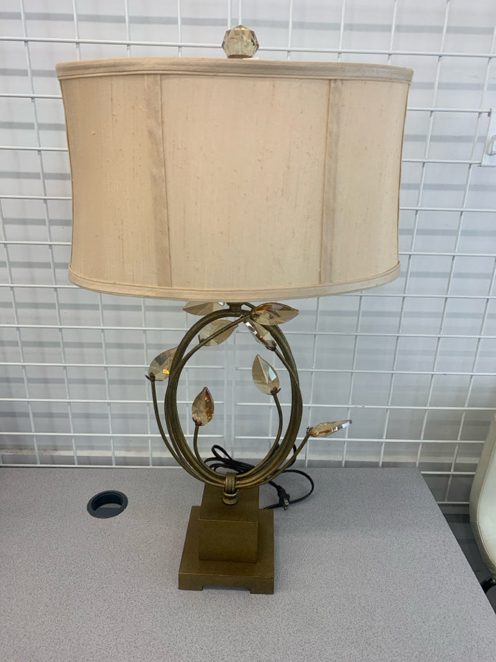 GOLD BASE LAMP W/CRYSTAL LEAVES AND CREAM SHADE.
