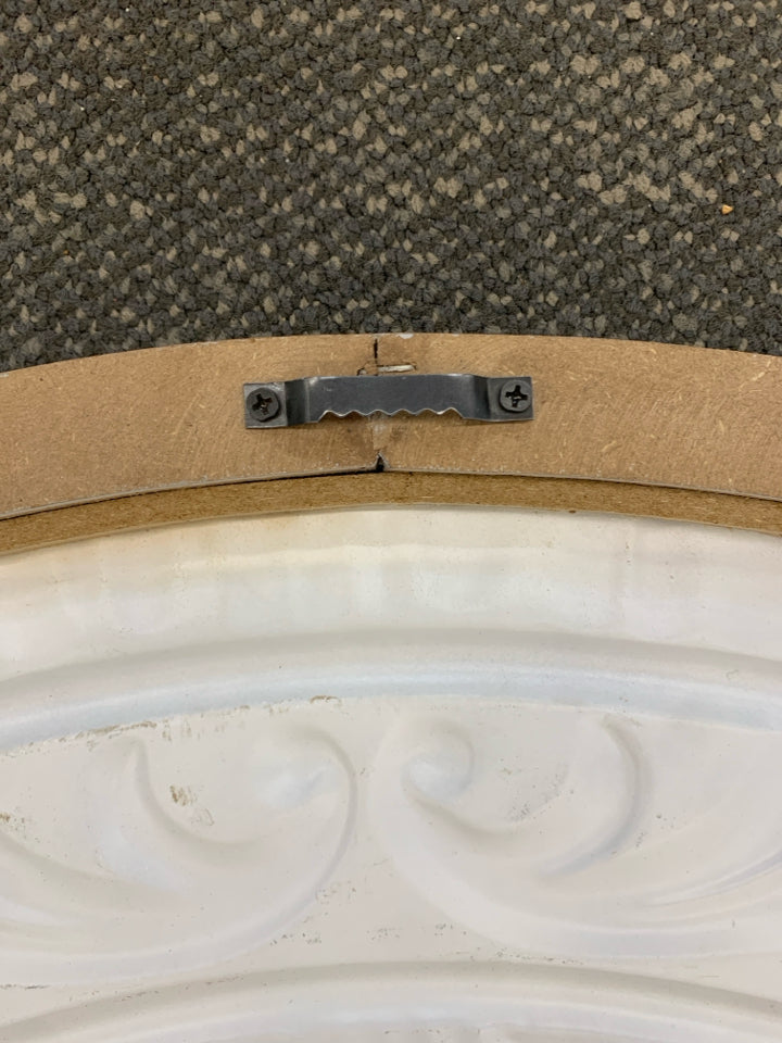 DISTRESSED HALF-CIRCLE METAL MEDALLION.