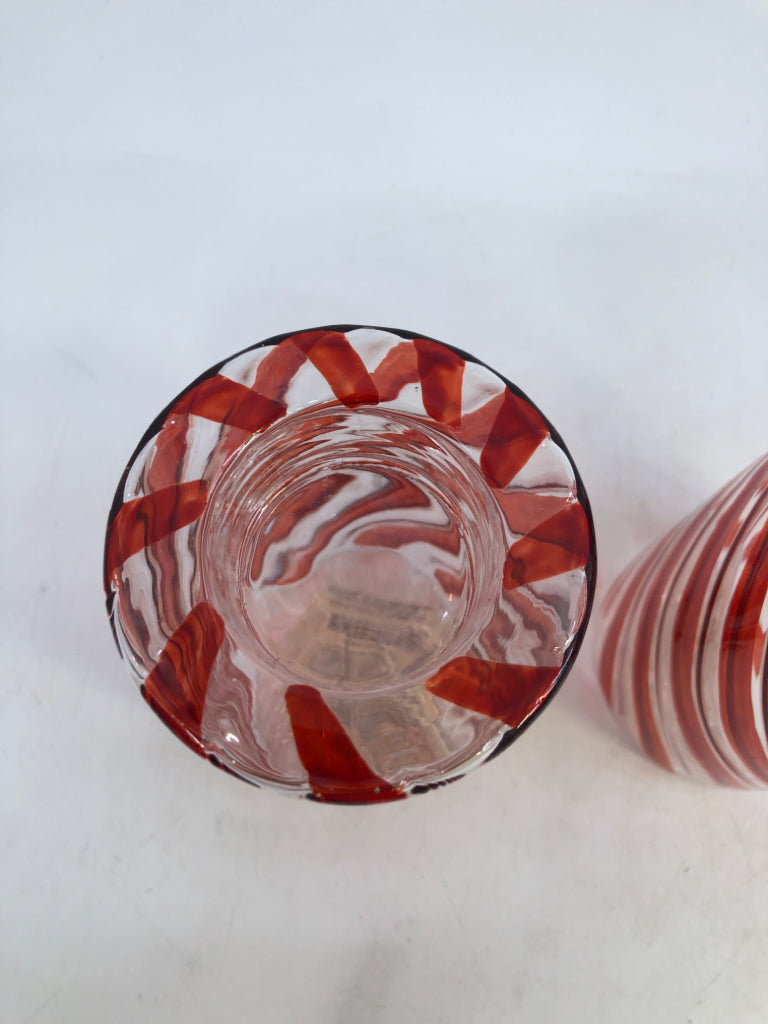 2 GLASS RED SWIRL CANDLE HOLDERS.