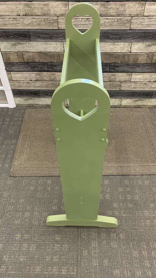 GREEN PAINTED QUILT RACK W/HEART CUTOUTS.