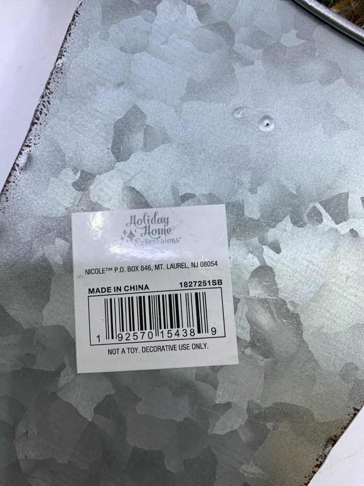 METAL STOCKING PAINTED WHITE W/ HOLLY AND GREENERY.