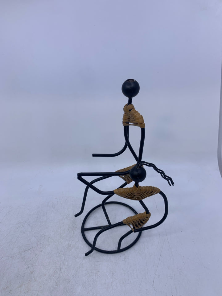 BLACK METAL 2 PEOPLE HOLDING HANDS W/ 1 LEG UP FOLK ART.