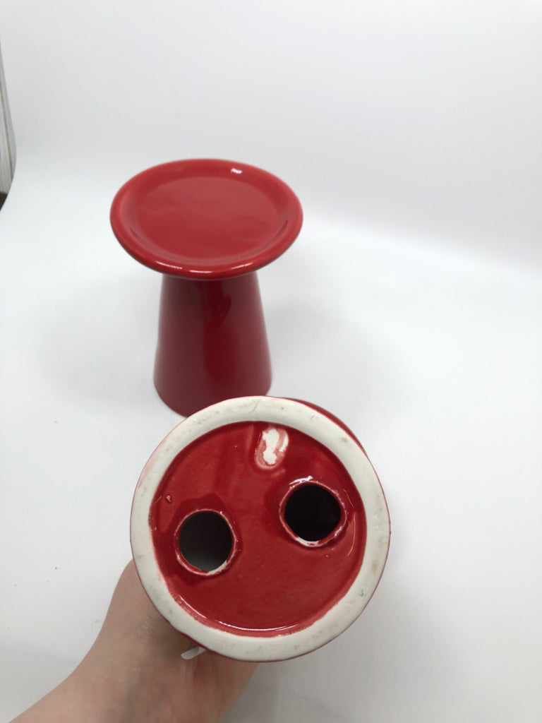 2 RED CERAMIC CANDLE HOLDERS.