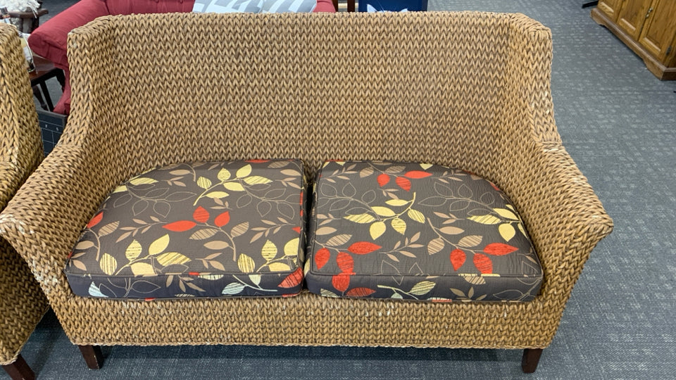 WICKER SOFA W/BROWN CUSHION.