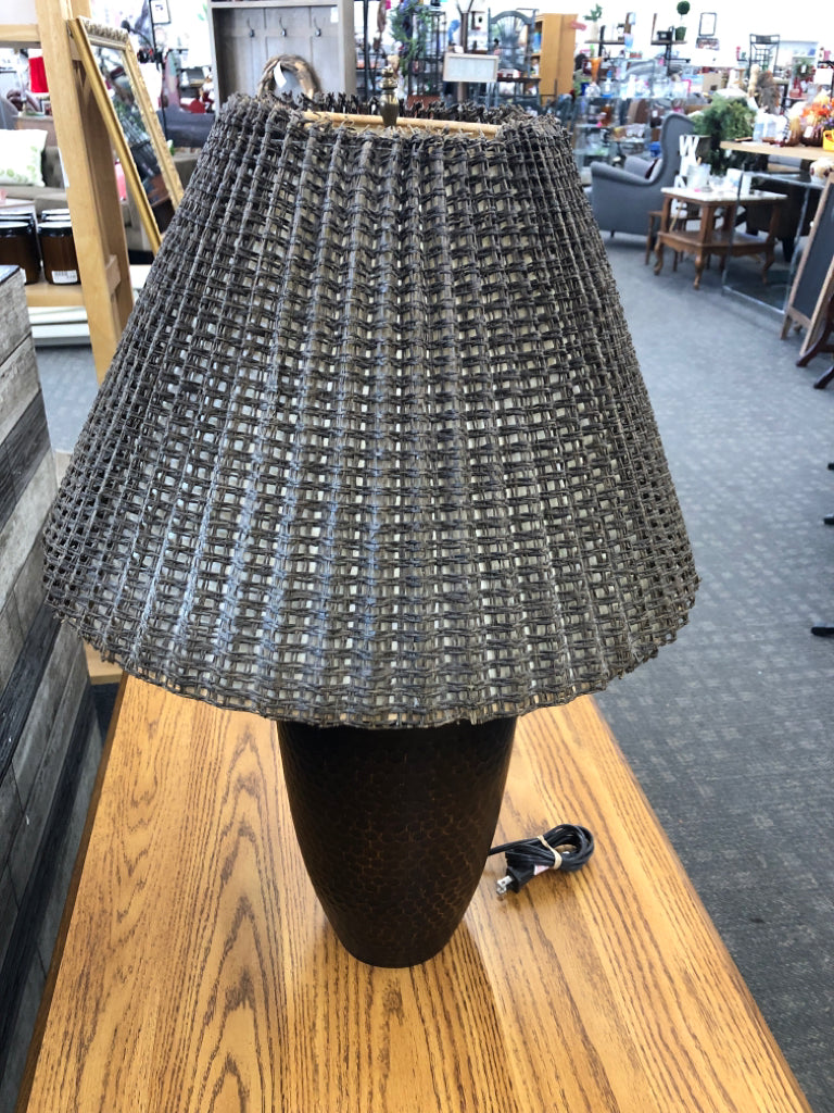 BRONZE BASE LAMP W/BROWN WICKER SHADE.