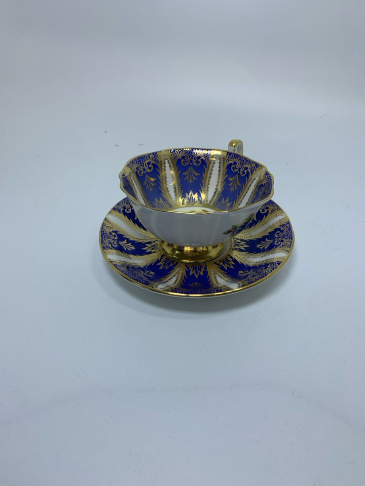 COBALT BLUE & GOLD DETAILED W/ FRUIT IN CENTER.
