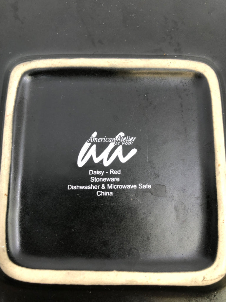 BLACK STONEWARE PLATE W/RED DAISY PATTERN.