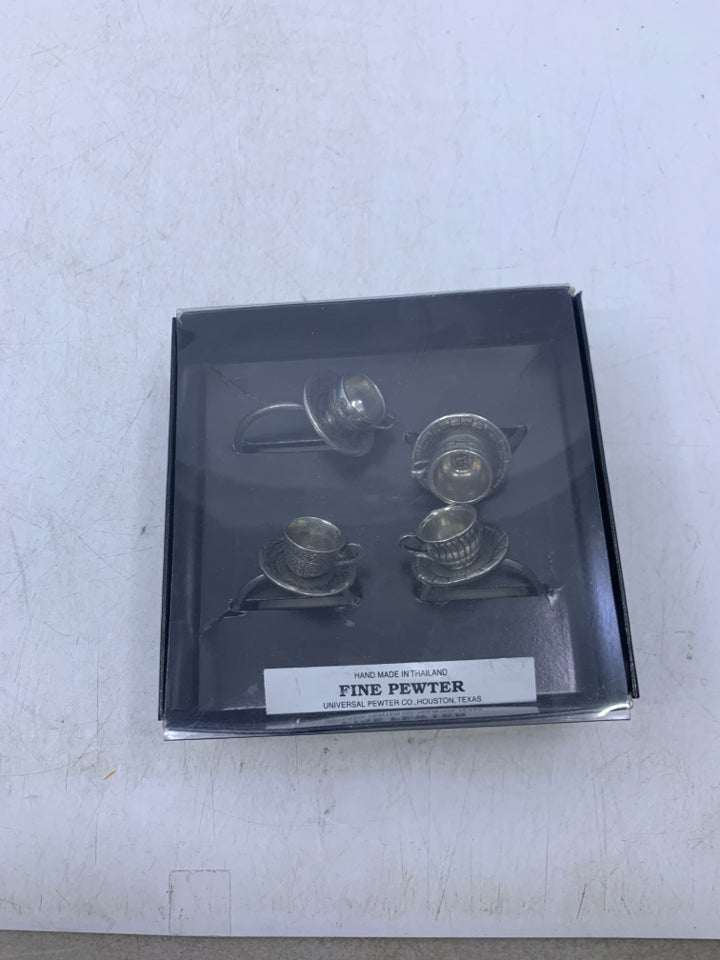 IN BOX 4 PEWTER TEACUP NAPKIN RINGS.