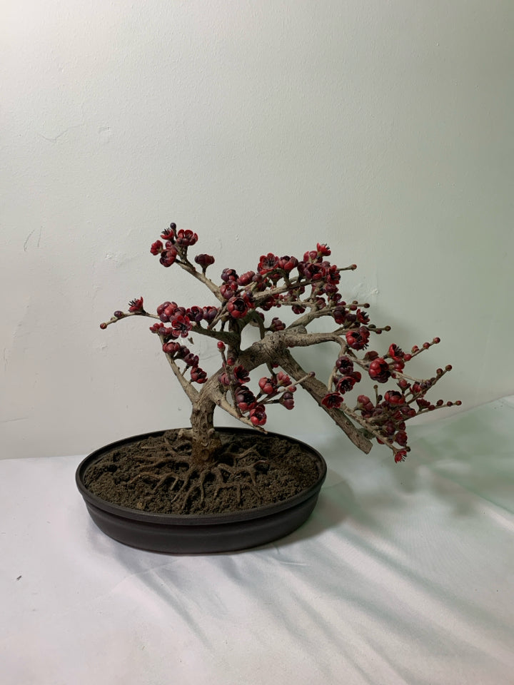 FAUX BONSAI TREE W/ RED FLOWERS IN OVAL PLANTER.