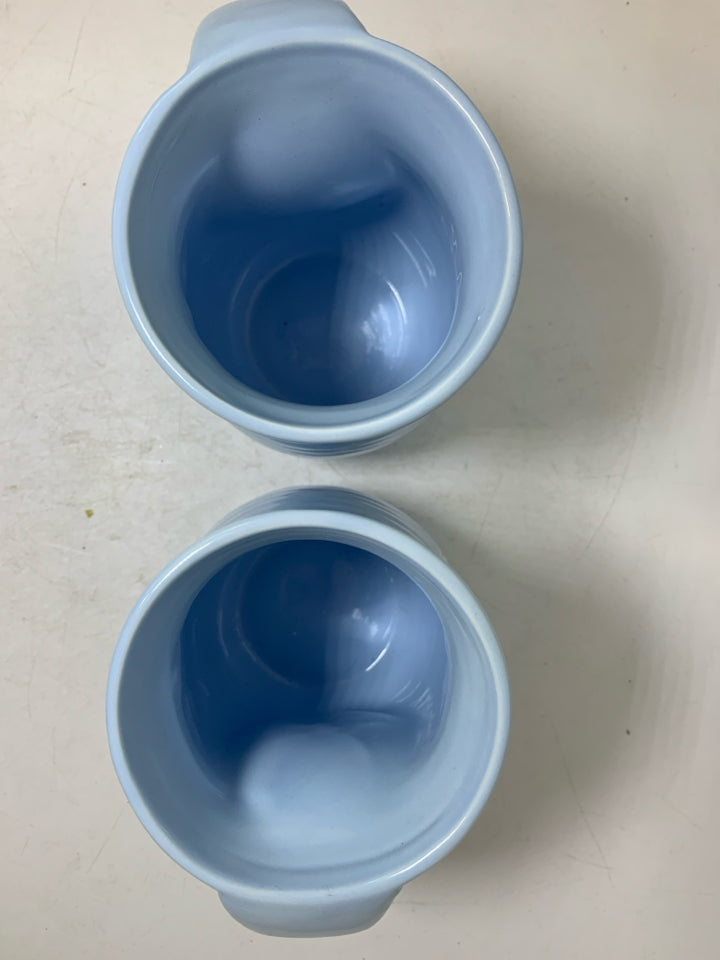 2 LIGHT BLUE MUGS W/ SNOWFLAKE IN CENTER.