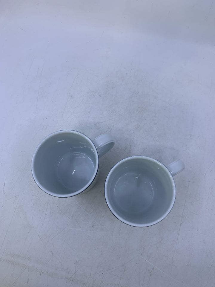 2 WHITE RIBBED MUGS W/ BLUE RIM.