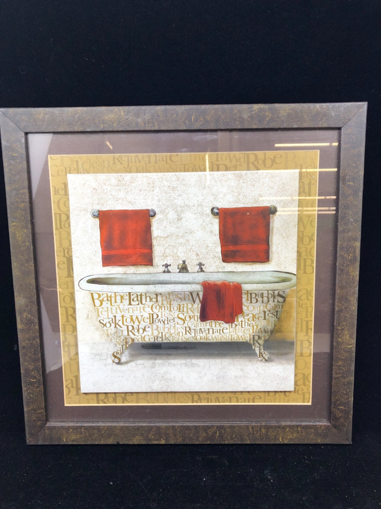 BATHTUB W WORDS AND RED TOWELS.