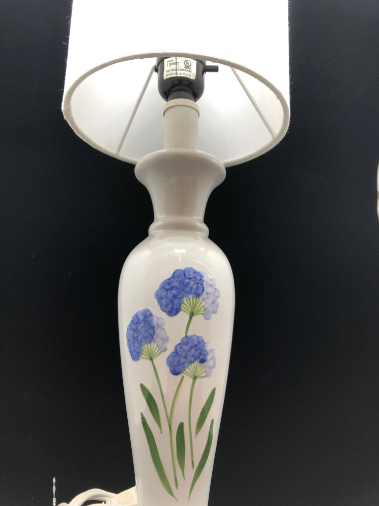 WHITE CERAMIC LAMP W/BLUE FLOWERS AND WHITE SHADE.