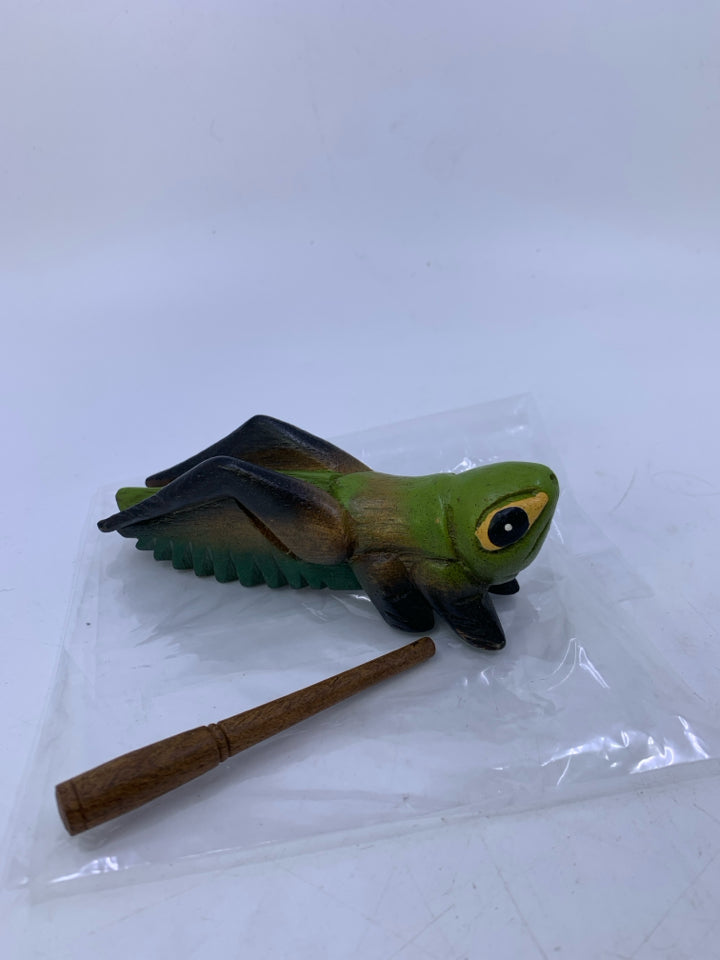 WOOD PAINTED/CARVED GRASS HOPPER MUSIC INSTRUMENT W/ WOOD STICK IN BAG.