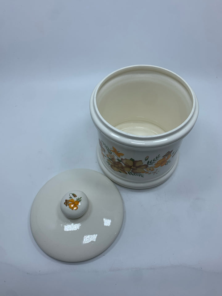 WHITE CERAMIC CANISTER W/BROWN AND ORANGE FLOWERS.