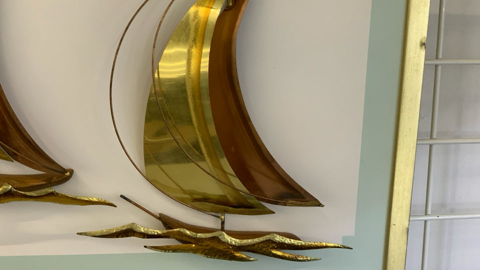 BRONZE METAL SHIPS MOUNTED ON GOLD FRAME.
