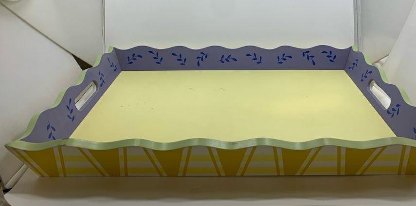 YELLOW WOOD TRAY W/BLUE PAINTED LEAVES AND WAVY EDGE.