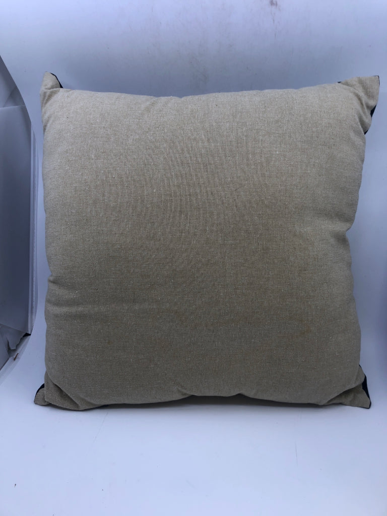 BLACK AND TAN PILLOW.