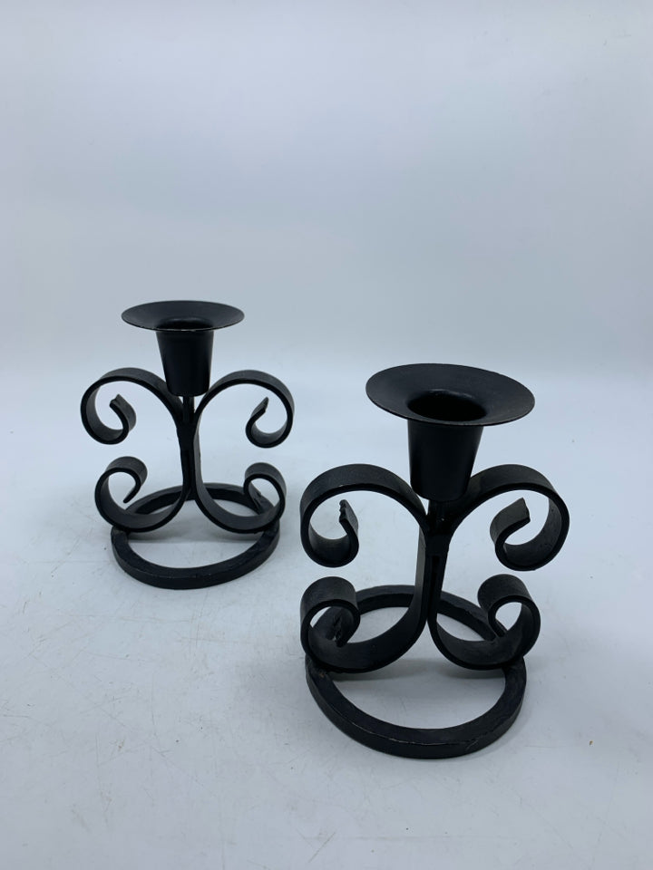 2 BLACK METAL SCROLL TAPERED CANDLE HOLDERS.