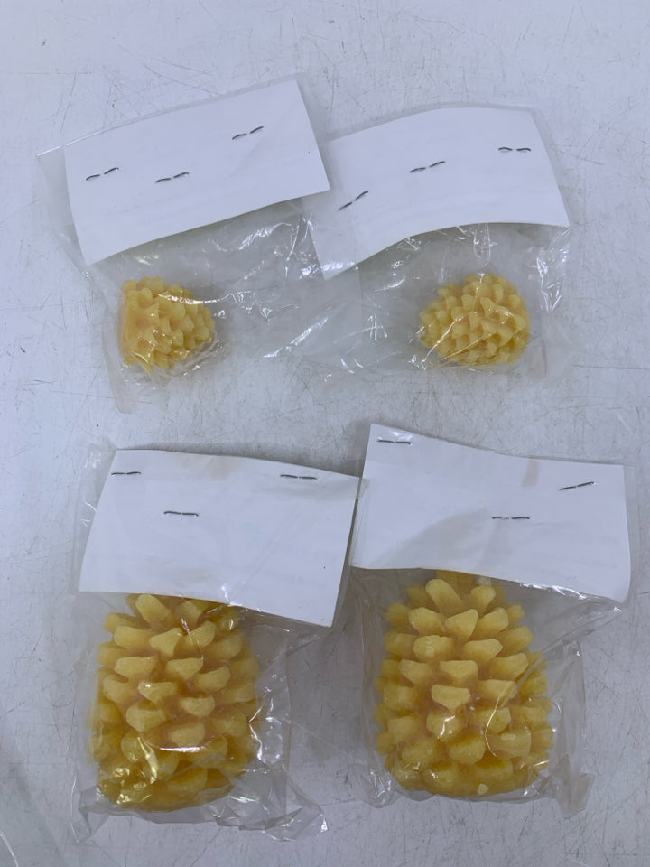 4 ASSORTED PINECONE SHAPED BEES WAX CANDLES IN BAG.