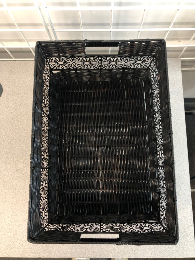 BLACK WOVEN BASKET W/METAL SIDE DETAIL.