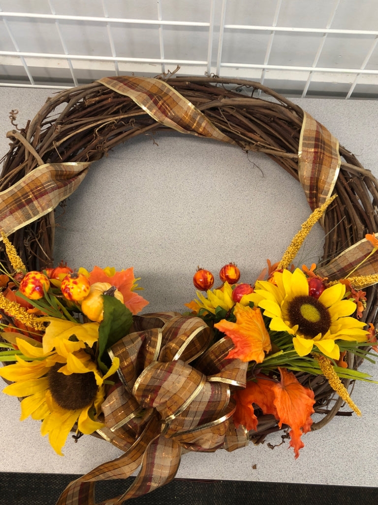 FAUX TWIG WREATH W/SUNFLOWERS AND PLAID BOW.