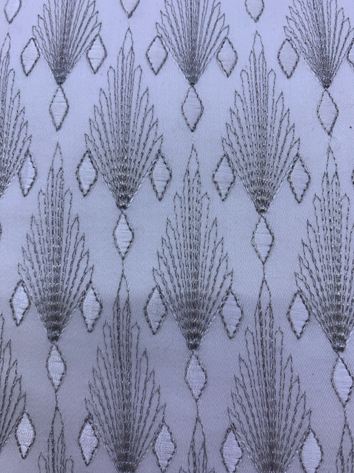 WHITE AND SILVER PATTERN PILLOW.