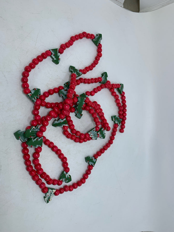 RED BEADED GARLAND W/ CHRISTMAS TREES.