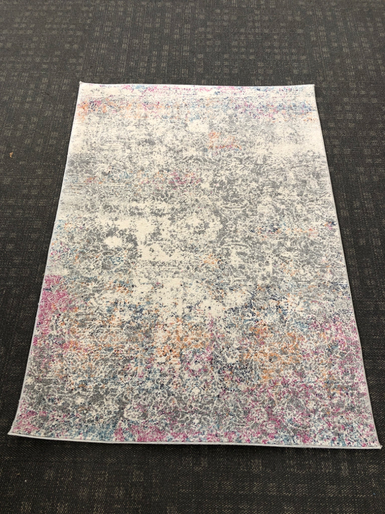 MULTI-COLORED ABSTRACT AREA RUG.
