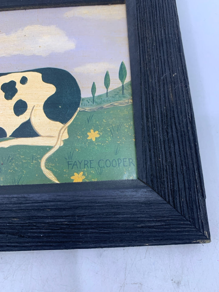 PRIMITIVE STYLE 2 COWS LAYING DOWN IN FIELD.