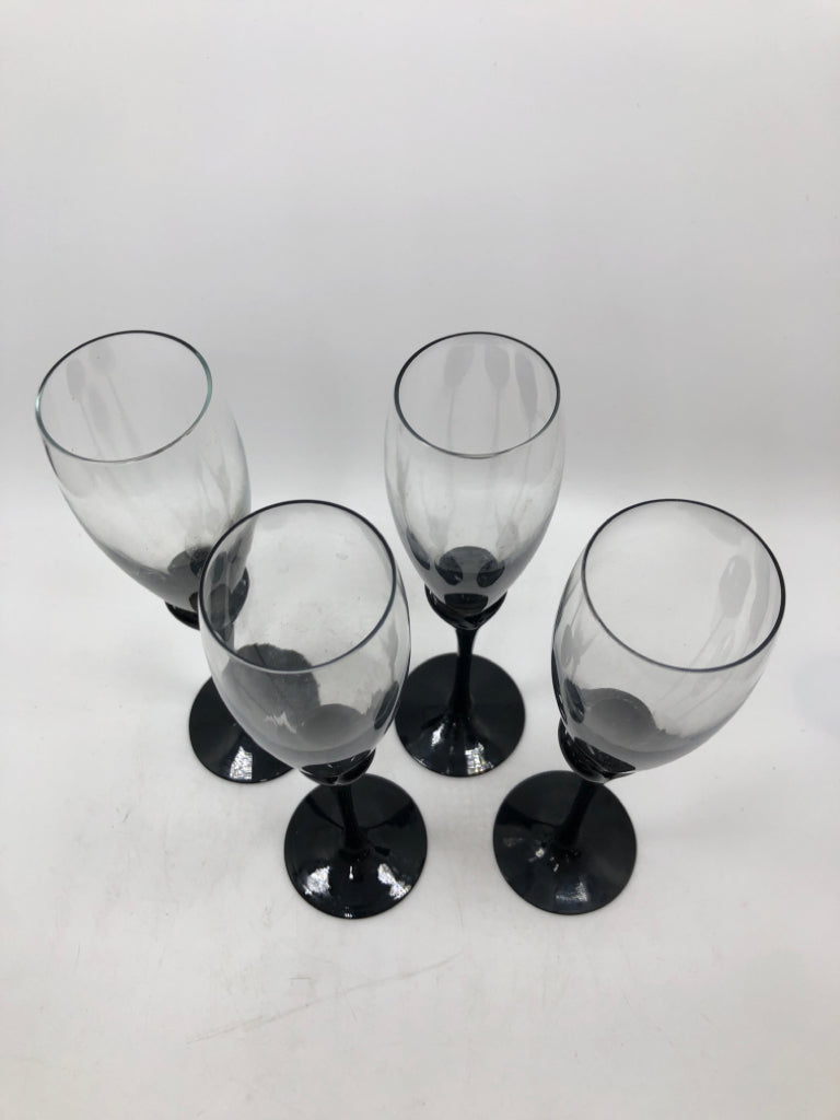 4 BLACK STEMMED CHAMPAGNE FLUTES.