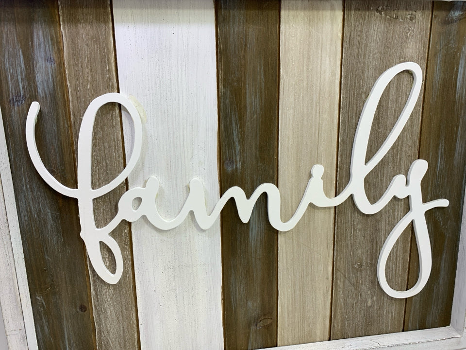 "FAMILY" ON WOOD SLATS IN WHITE FRAME.