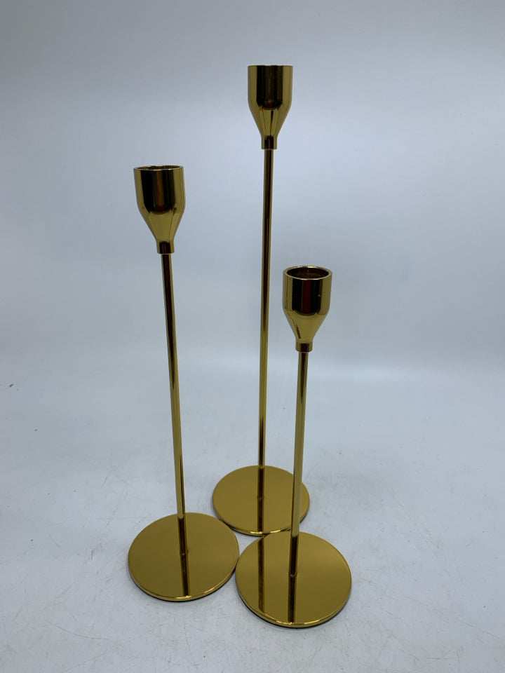 3 GOLD SKINNY TAPERED CANDLE HOLDERS DIFFERENT SIZES.