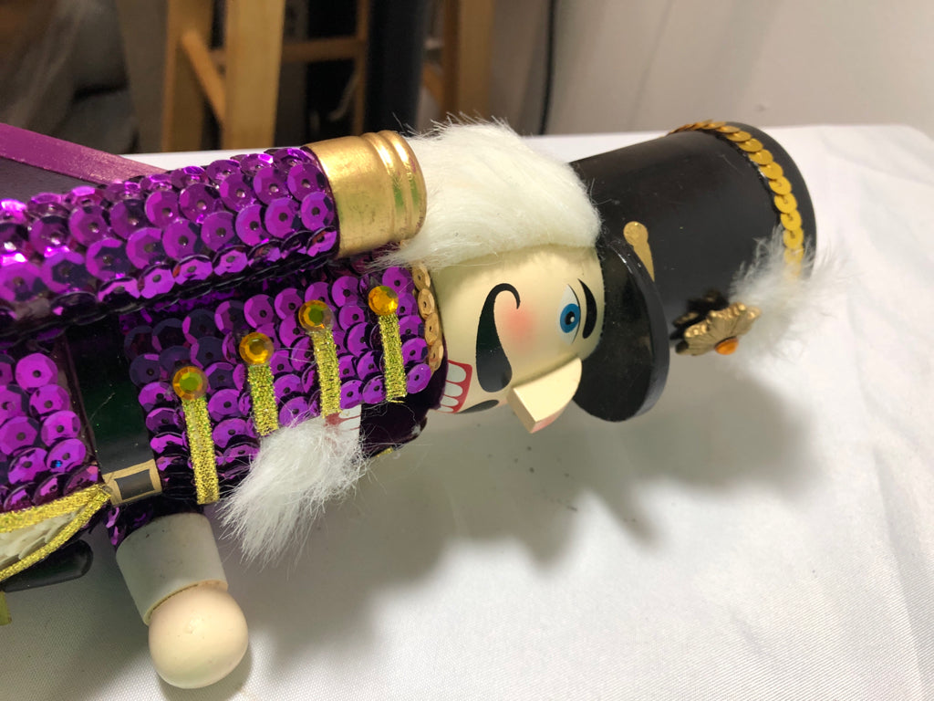 PURPLE SEQUIN NUT CRACKER.