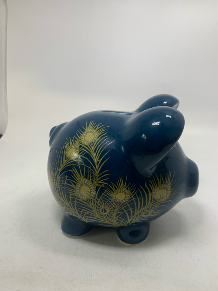 DARK BLUE PIGGY BANK W/ PEACOCK FEATHER DETAILS.