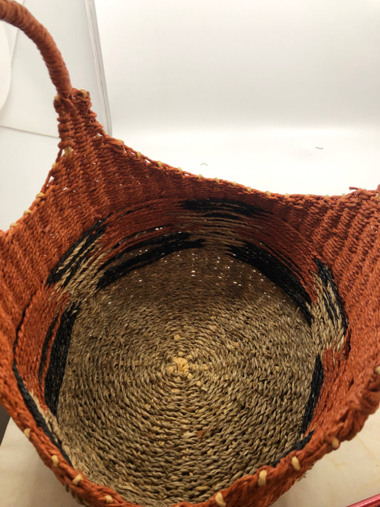 ORANGE AND TAN WICKER BASKET WITH BLUE ACCENTS.