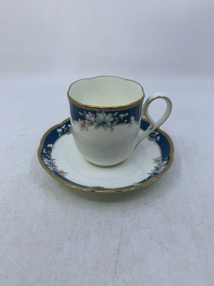 WHITE TEA CUP W/ BLUE/GOLD EDGE & FLOWERS.