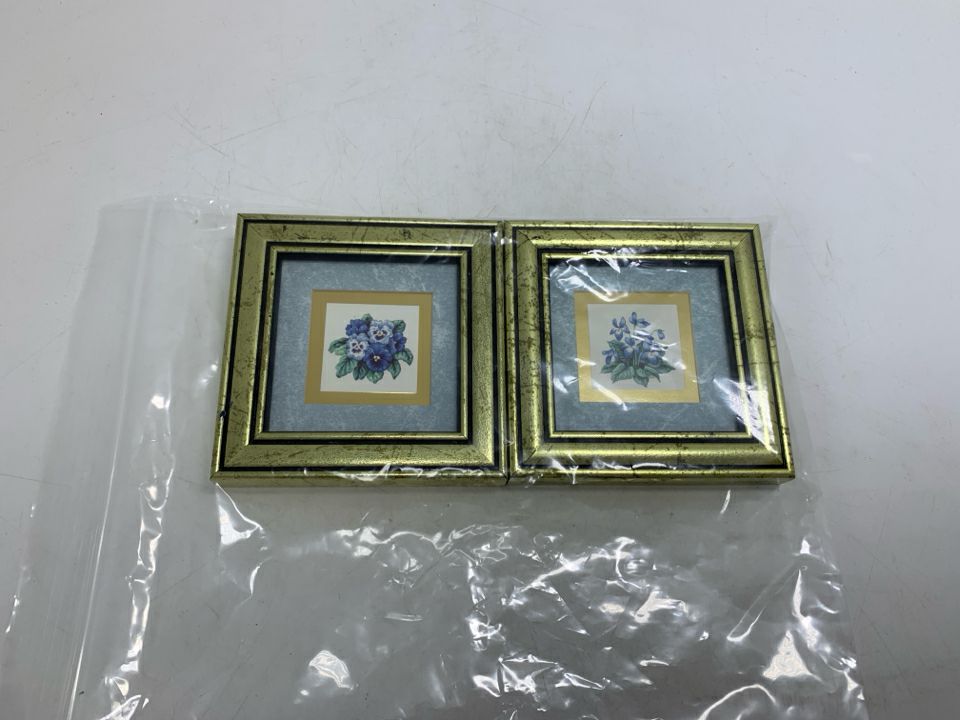 2 MINI VIOLET/PANSY FLOWER PICTURES IN GOLD FRAMES IN BAG.