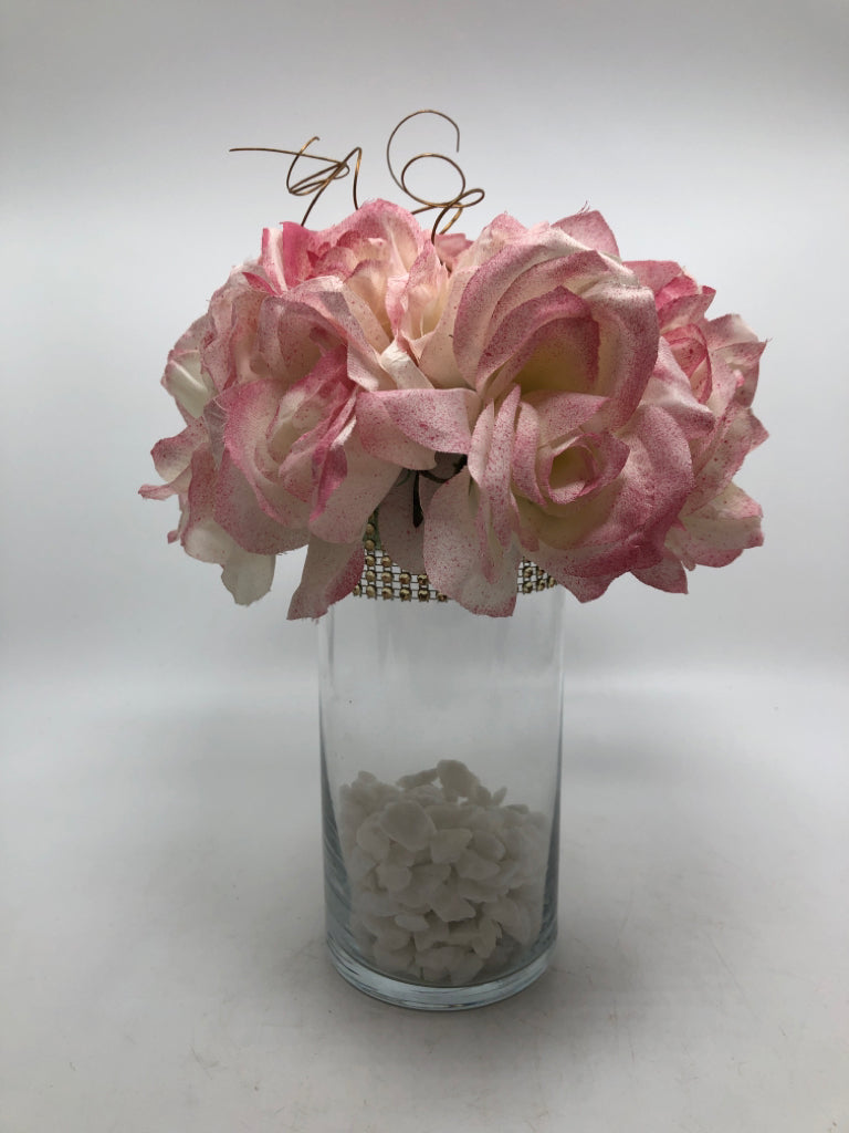 WHITE ROCK FILLED VASE W/PINK FLORALS.