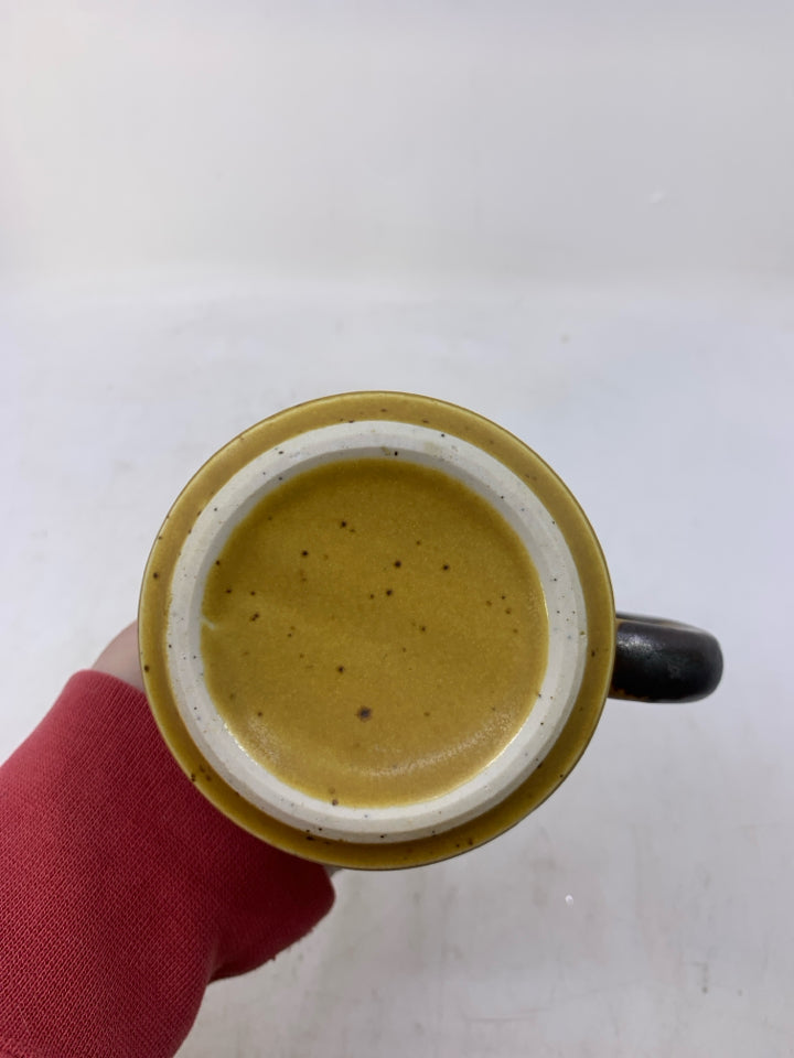 MUSTARD YELLOW POTTERY MUG W/ BROWN FLOWER DESIGN.
